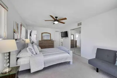 a bedroom with a bed and a ceiling fan at Cozy Poconos Mountain House with 3 bedrooms in Tobyhanna