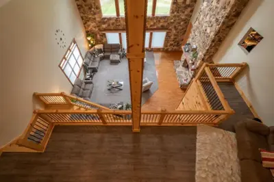 an overhead view of a living room with a wooden staircase at The Mountain Lodge in Elliottsburg