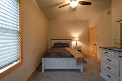 a bedroom with a bed and a ceiling fan at The Mountain Lodge in Elliottsburg