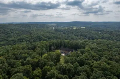 an aerial view of a house in the middle of a forest at The Mountain Lodge in Elliottsburg