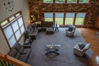 a large living room with couches and a table at The Mountain Lodge in Elliottsburg