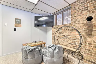 a room with a brick wall and a hose at Lake Ariel Home Less Than 1 Mi to Roaming Woods Lake! in Lake Ariel