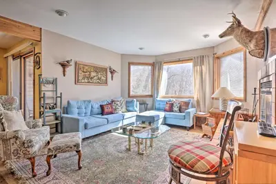 a living room with blue couches and a table at Next to Shawnee Mtn Ski Area Inviting Condo! in East Stroudsburg