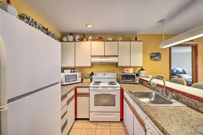 a kitchen with a white stove top oven next to a sink at Next to Shawnee Mtn Ski Area Inviting Condo! in East Stroudsburg