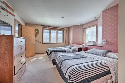 a bedroom with two beds and a dresser at Next to Shawnee Mtn Ski Area Inviting Condo! in East Stroudsburg