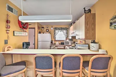 a kitchen with a large counter with chairs around it at Next to Shawnee Mtn Ski Area Inviting Condo! in East Stroudsburg