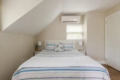 a bedroom with a large bed with blue and white stripes at Boat House in Downingtown