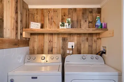 a kitchen with a stove and a washer and dryer at 5 bd w Hottub - mins to Hunting Hiking & Fishing in New Providence