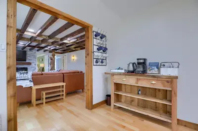 a room with a bed and a kitchen with a table at 5 bd w Hottub - mins to Hunting Hiking & Fishing in New Providence