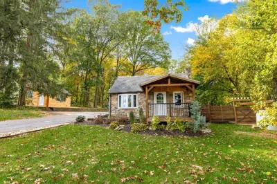 a cabin in a yard with a fence at 5 bd w Hottub - mins to Hunting Hiking & Fishing in New Providence