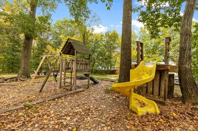 a playground with a slide and a swing set at 5 bd w Hottub - mins to Hunting Hiking & Fishing in New Providence