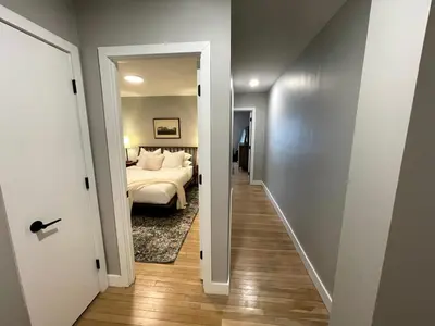 a hallway leading to a bedroom with a bed at 2BR in Heart of Queen Village - walk to everything! in Philadelphia