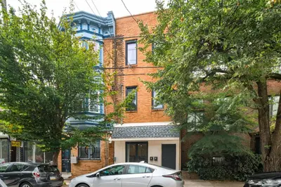 a white car parked in front of a brick building at 2BR in Heart of Queen Village - walk to everything! in Philadelphia
