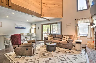 a living room with two couches and a table at Tobyhanna Cabin with Deck, Community Pool and Golf! in Tobyhanna