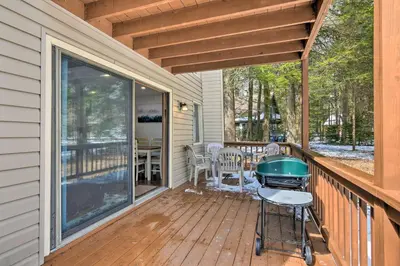 a screened in porch with a grill on a deck at Tobyhanna Cabin with Deck, Community Pool and Golf! in Tobyhanna
