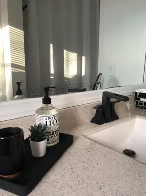 a bathroom counter with a bottle of mouthwash and a sink at Catskills Cottage with Lake View Book Now in Rock Hill