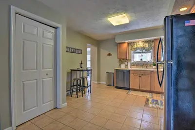 a kitchen with a refrigerator and a table at 1 Mi to Lake Family-Friendly Tobyhanna Home in Tobyhanna