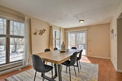 a dining room with a wooden table and chairs at 1 Mi to Lake Family-Friendly Tobyhanna Home in Tobyhanna