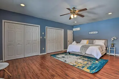 a bedroom with blue walls and a bed with a ceiling fan at 1 Mi to Lake Family-Friendly Tobyhanna Home in Tobyhanna