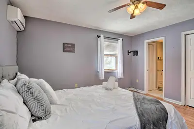 a bedroom with a large white bed and a ceiling fan at 1 Mi to Lake Family-Friendly Tobyhanna Home in Tobyhanna