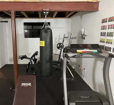a room with a gym with a punching bag and a treadmill at 5BRwithBand&Piano setup Private Gym Theater&Entry at Cherry Hill in Cherry Hill