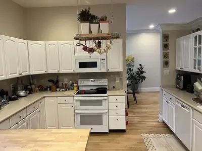 a kitchen with white cabinets and white appliances at 5BRwithBand&Piano setup Private Gym Theater&Entry at Cherry Hill in Cherry Hill