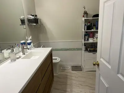 a white bathroom with a sink and a toilet at 5BRwithBand&Piano setup Private Gym Theater&Entry at Cherry Hill in Cherry Hill