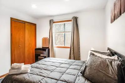a bedroom with a bed and a window at Highland Hideaway in East Stroudsburg