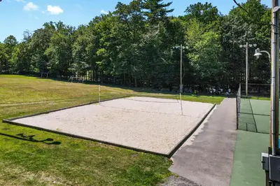 a tennis court with a net in a park at Highland Hideaway in East Stroudsburg