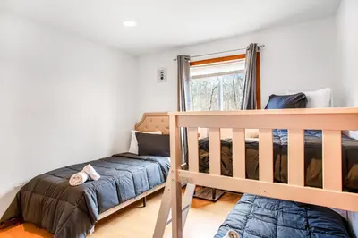 a bedroom with a bunk bed and a crib at Highland Hideaway in East Stroudsburg