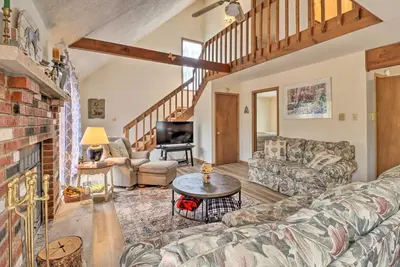 a living room with a couch and a table at about 1 Mi to Lake Secluded Poconos Home with Decks in Jim Thorpe