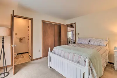 a bedroom with a bed and a door to a hallway at about 1 Mi to Lake Secluded Poconos Home with Decks in Jim Thorpe
