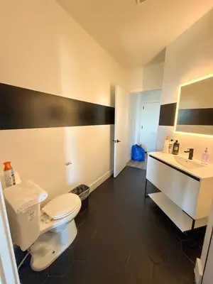a bathroom with a white toilet and a sink at Luxury Apartments - Newark Int Airport - Evonify Stays in Elizabeth
