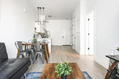 a living room and kitchen with a table and chairs at Luxury Apartments - Newark Int Airport - Evonify Stays in Elizabeth