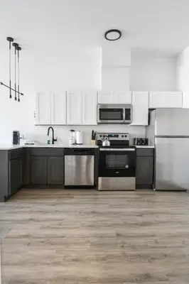 a kitchen with white cabinets and stainless steel appliances at Luxury Apartments - Newark Int Airport - Evonify Stays in Elizabeth