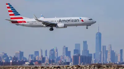 an airplane is taking off from a runway in front of a city at MOTELCASA Guest House Newark NJ in Newark