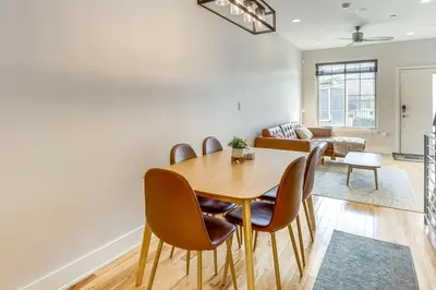 a dining room and living room with a table and chairs at 3-Story Philly Townhouse 2 Mi to University City! in Philadelphia