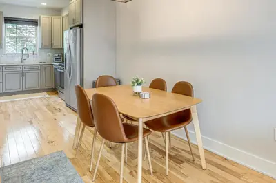 a kitchen with a wooden table and chairs at 3-Story Philly Townhouse 2 Mi to University City! in Philadelphia