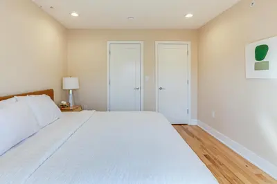 a bedroom with a large white bed in a room at 3-Story Philly Townhouse 2 Mi to University City! in Philadelphia