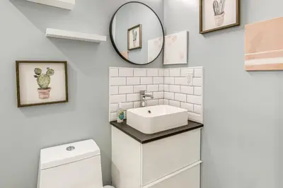 a bathroom with a sink and a mirror at 3-Story Philly Townhouse 2 Mi to University City! in Philadelphia