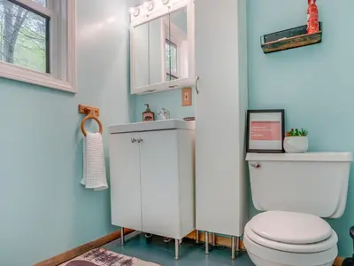 a bathroom with a toilet and a sink at Elmwood Elmwood Escape A Cozy Retreat at The Hideout in Hamlin