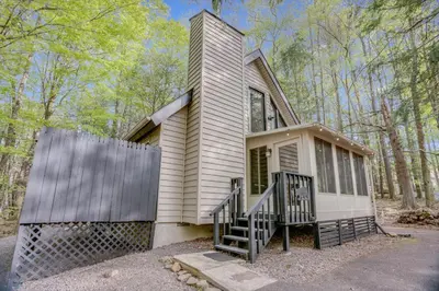 a small house with a staircase in the woods at Elmwood Elmwood Escape A Cozy Retreat at The Hideout in Hamlin