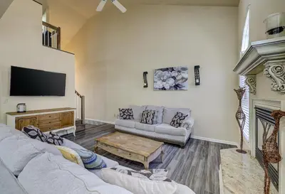 a living room with two couches and a flat screen tv at Pocono Retreat -1 Mile to Lake and Skiing! in Lake Harmony