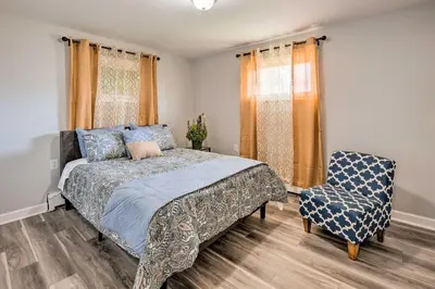 a bedroom with a bed and a chair at Updated Home with Pool Table about 4 Mi to Hershey! in Palmyra