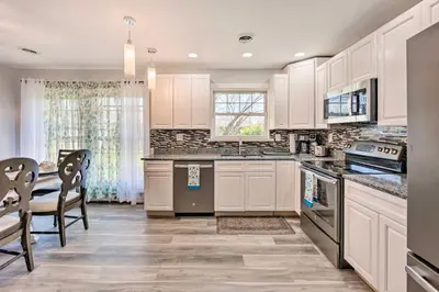 a kitchen with white cabinets and a table and chairs at Updated Home with Pool Table about 4 Mi to Hershey! in Palmyra