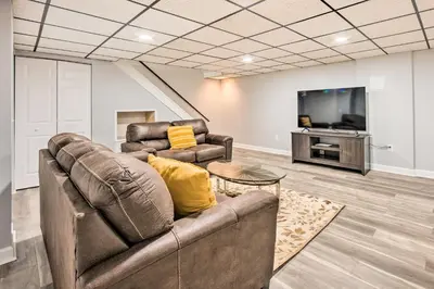 a living room with a couch and a tv at Updated Home with Pool Table about 4 Mi to Hershey! in Palmyra