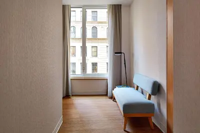 a room with a chair and a window at Hotel Indigo NYC Financial District by IHG in New York