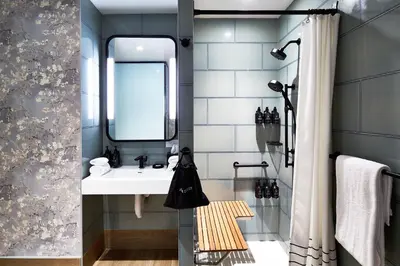 a bathroom with a sink and a mirror at Hotel Indigo NYC Financial District by IHG in New York