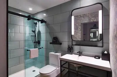 a bathroom with a toilet and a sink and a mirror at Hotel Indigo NYC Financial District by IHG in New York