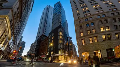 a busy city street with tall buildings and people at Hotel Indigo NYC Financial District by IHG in New York